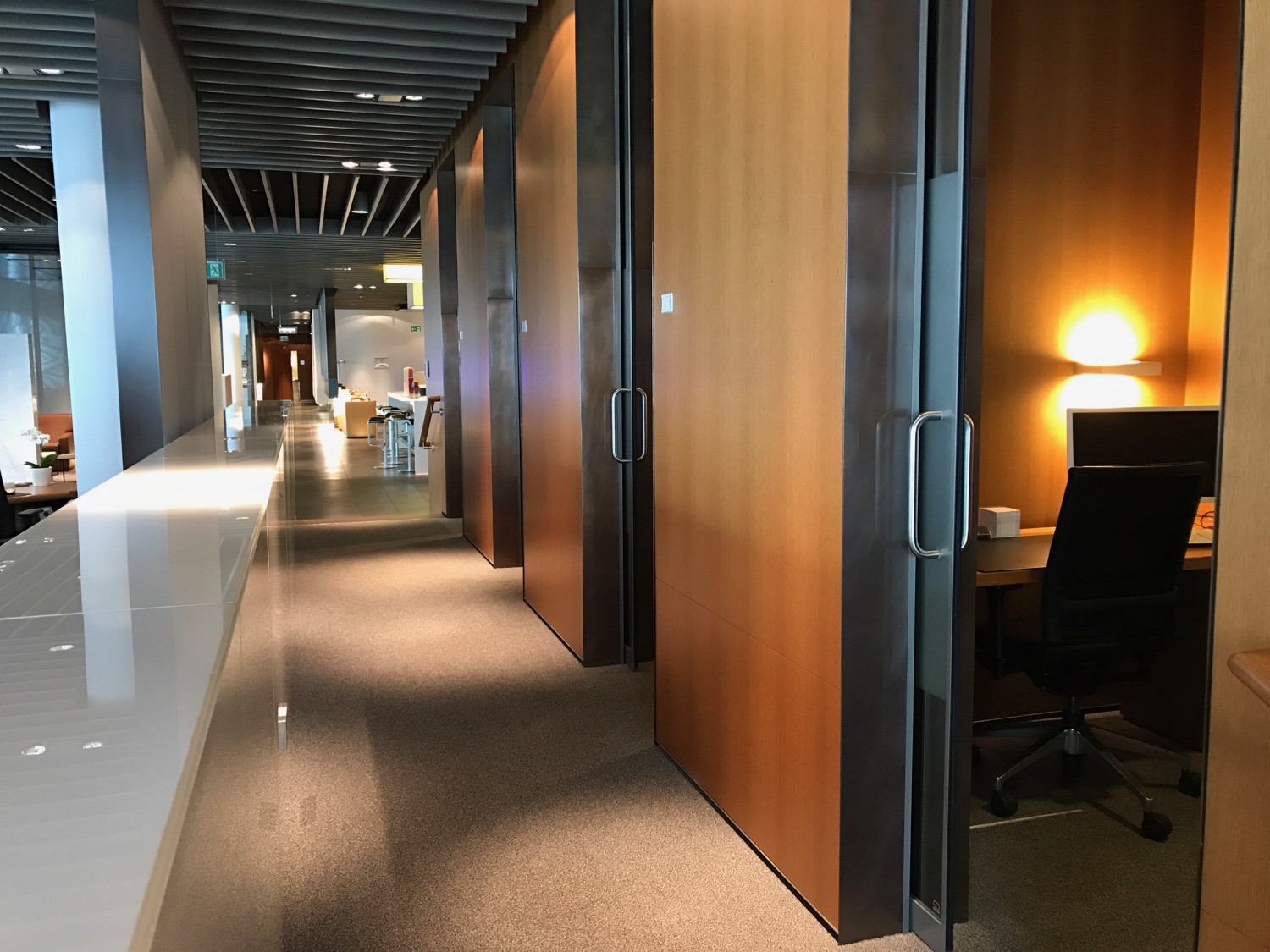 a hallway with doors and a desk