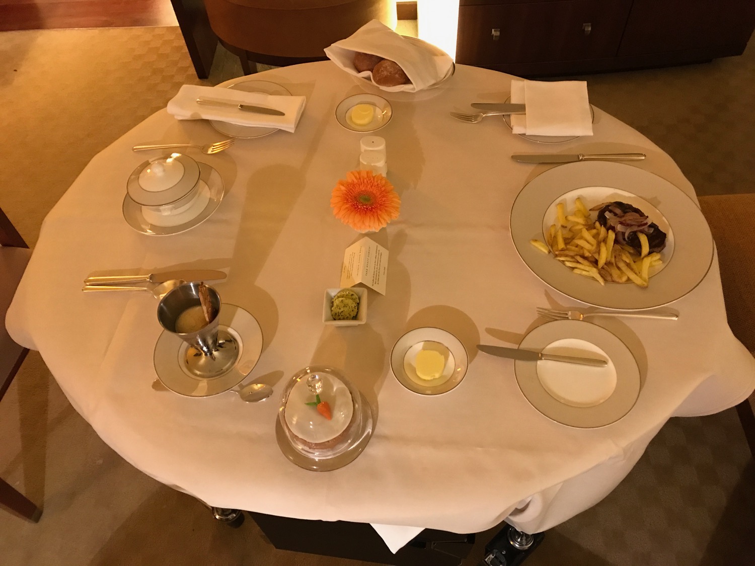 a table with plates of food and utensils