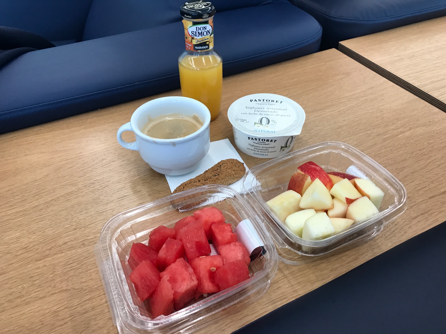 a tray of fruit and a cup of coffee on a table