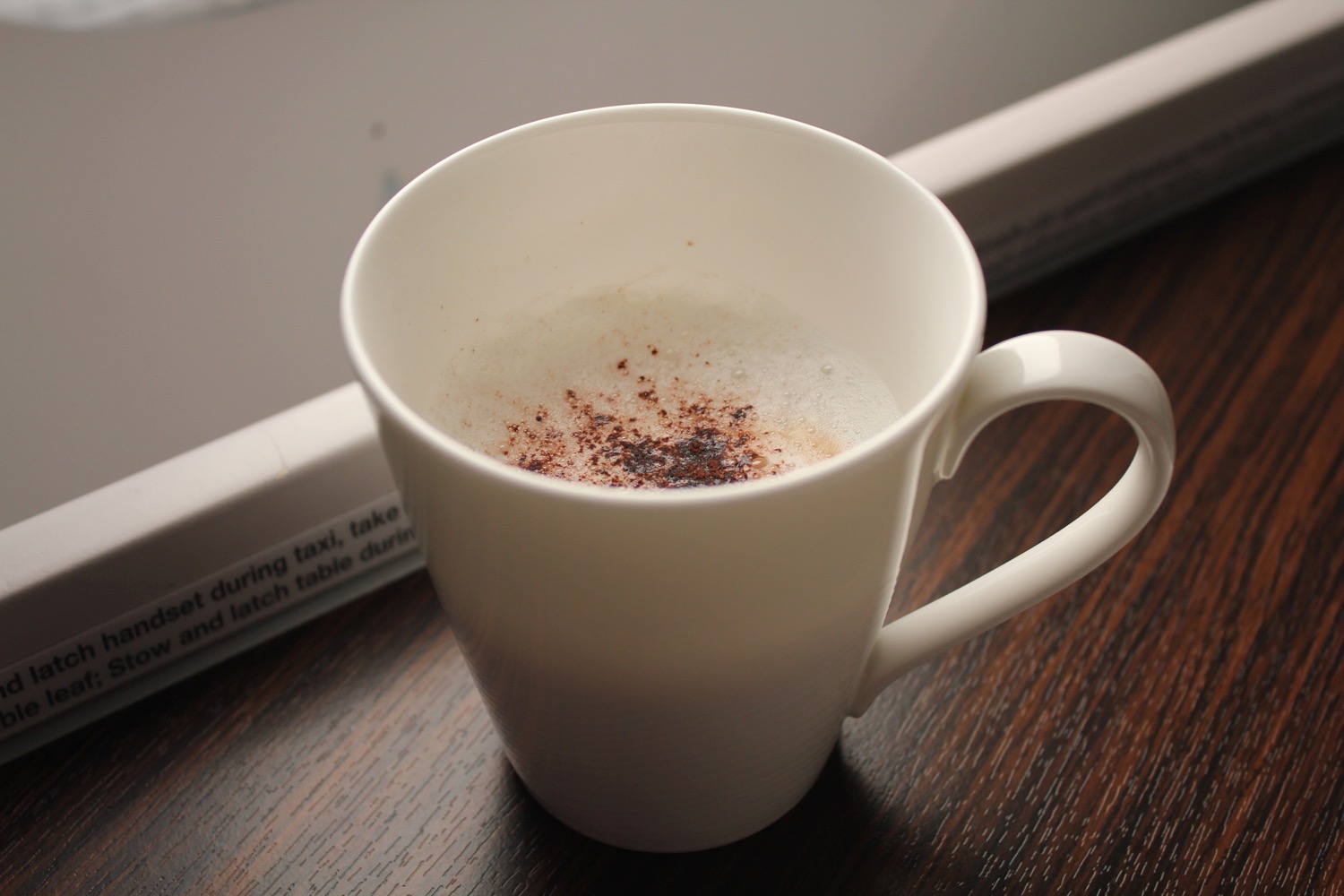 a white mug with brown powder in it
