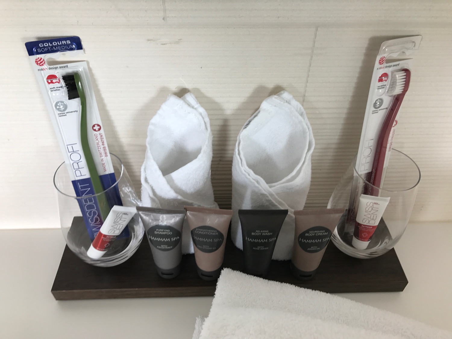 a group of toothbrushes and toothpaste on a shelf