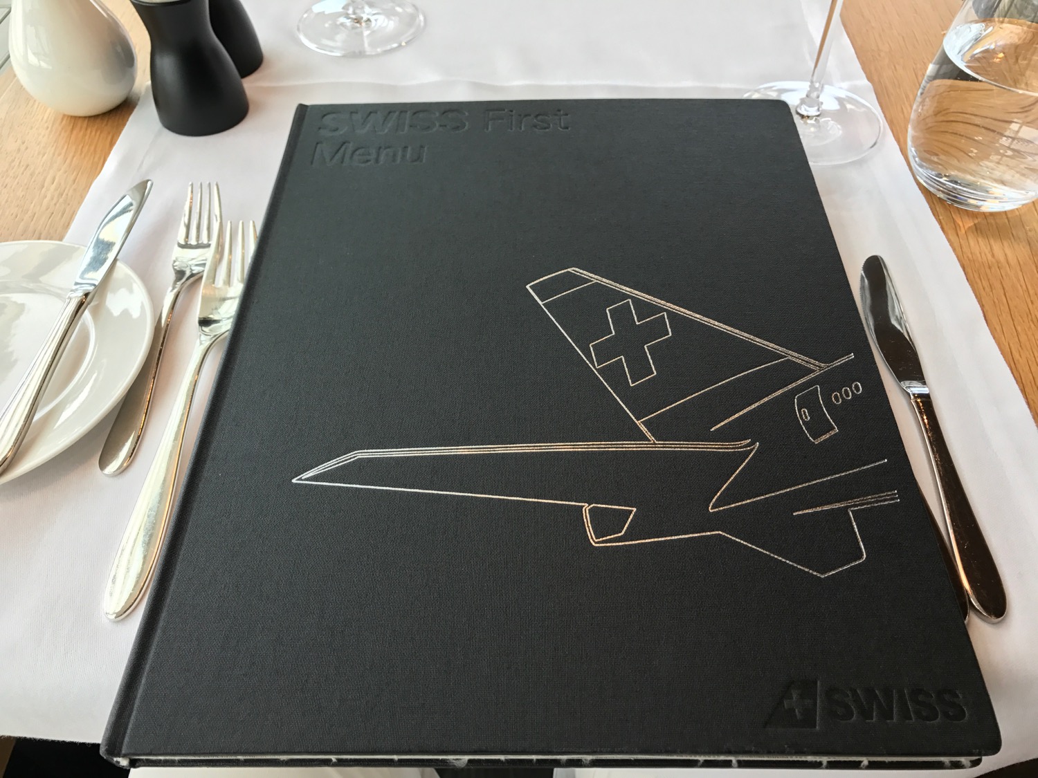 a black menu with a drawing of a plane on it