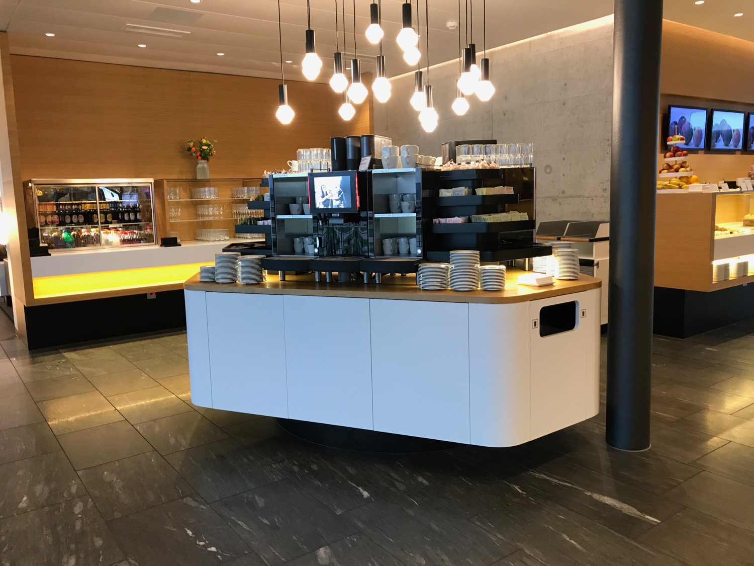 a coffee bar with a counter and a shelf