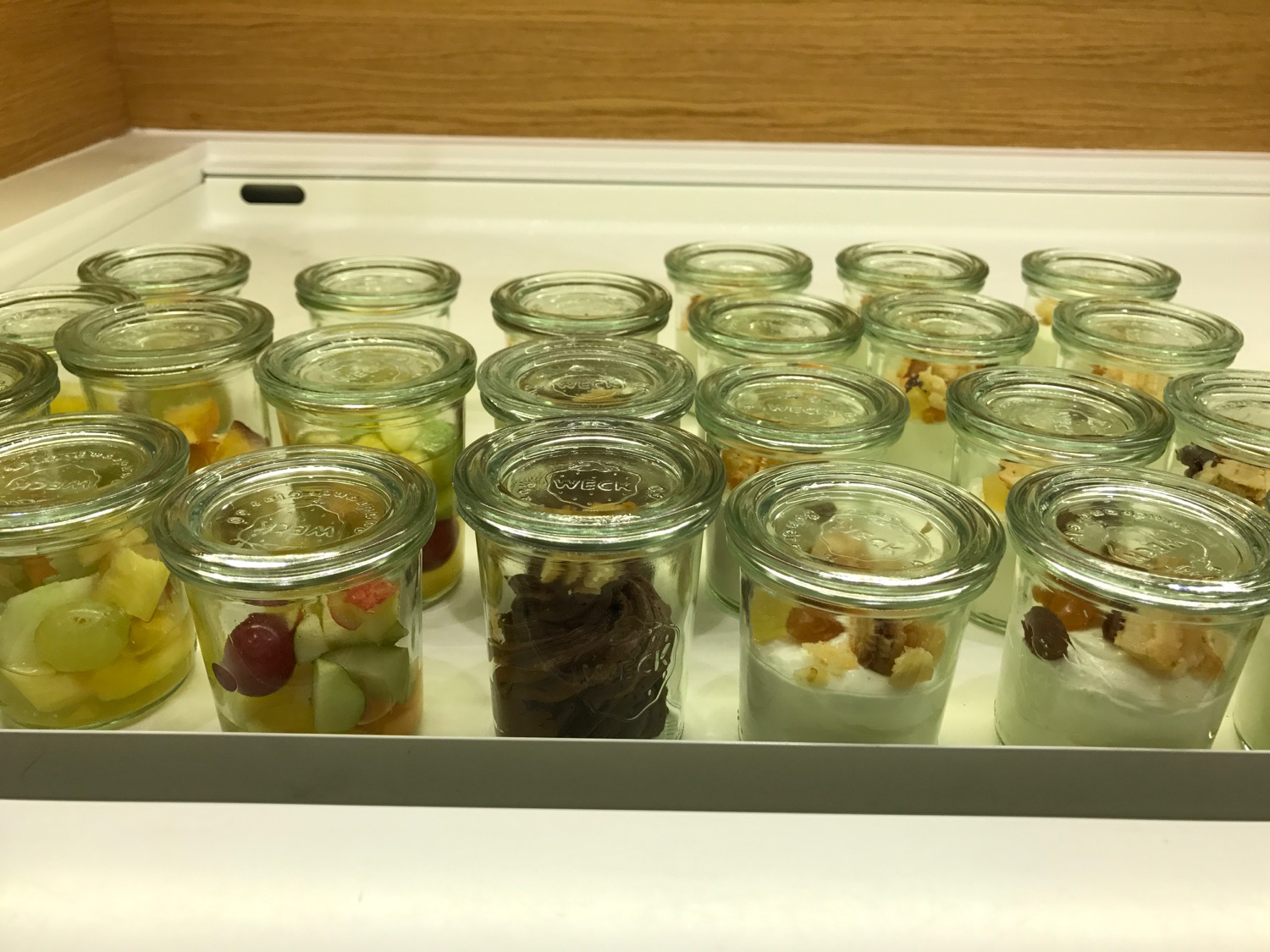 a group of glass jars with fruit in them
