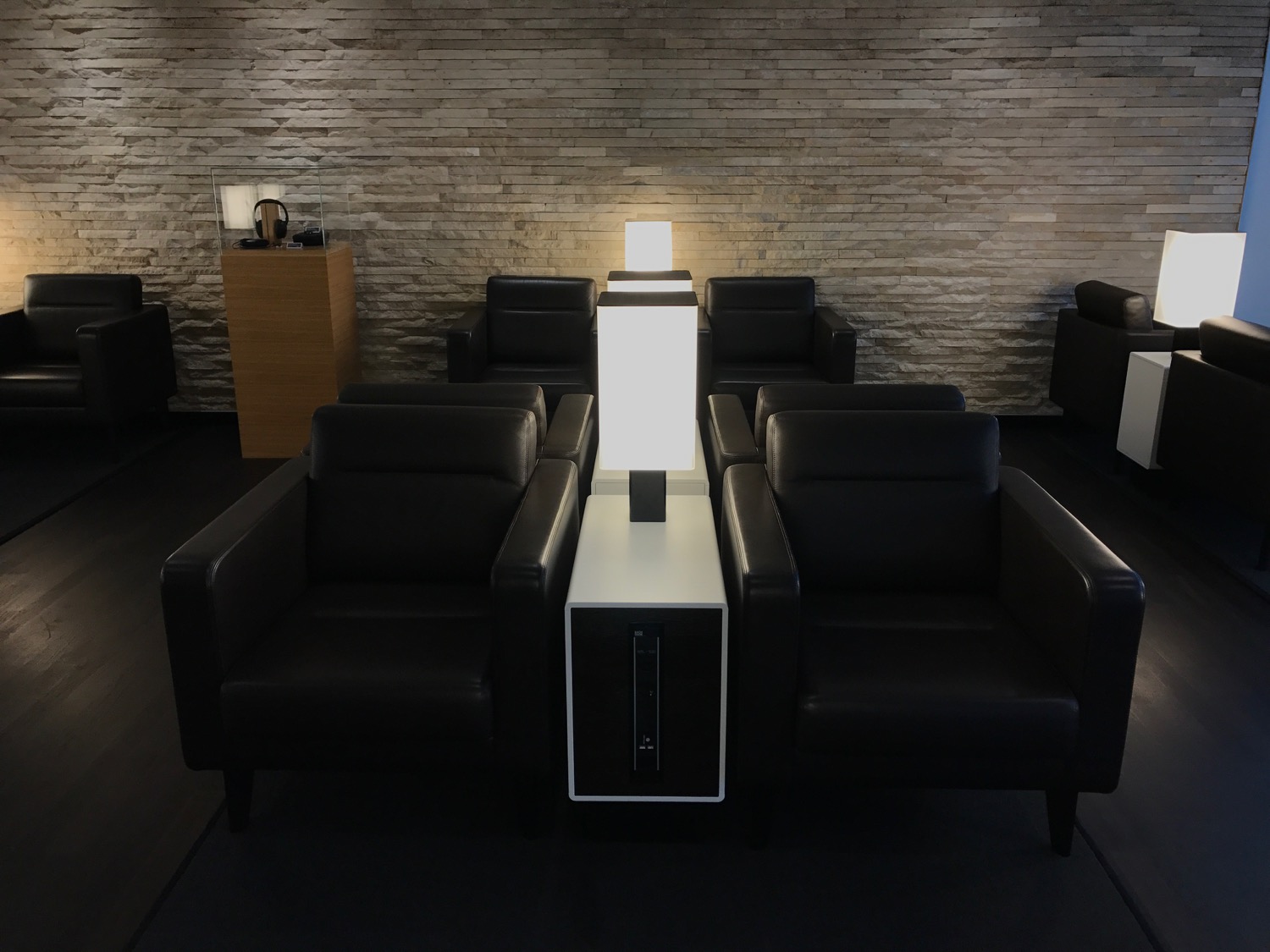 a room with black chairs and a white table