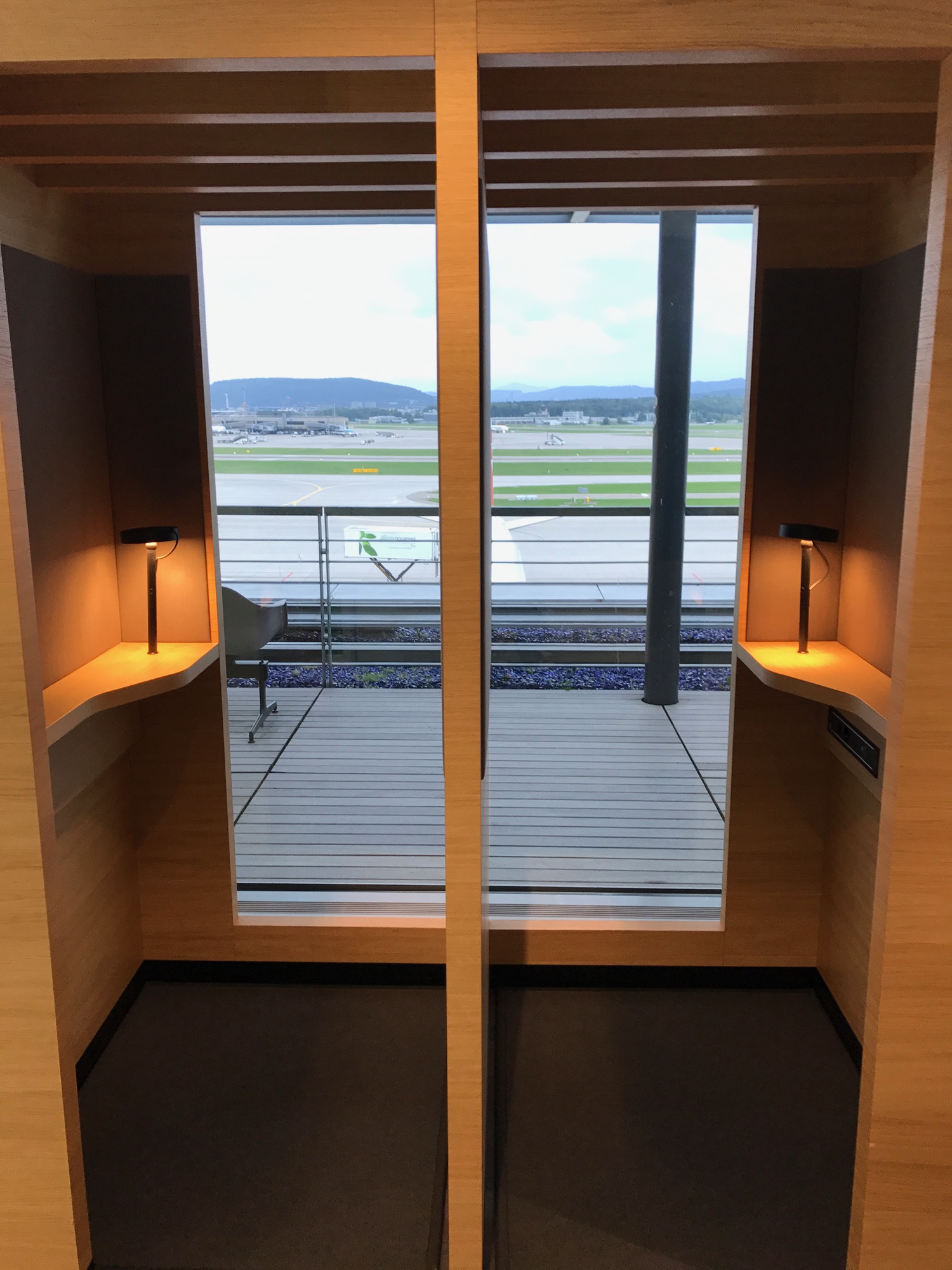 a room with a mirror and a view of the runway