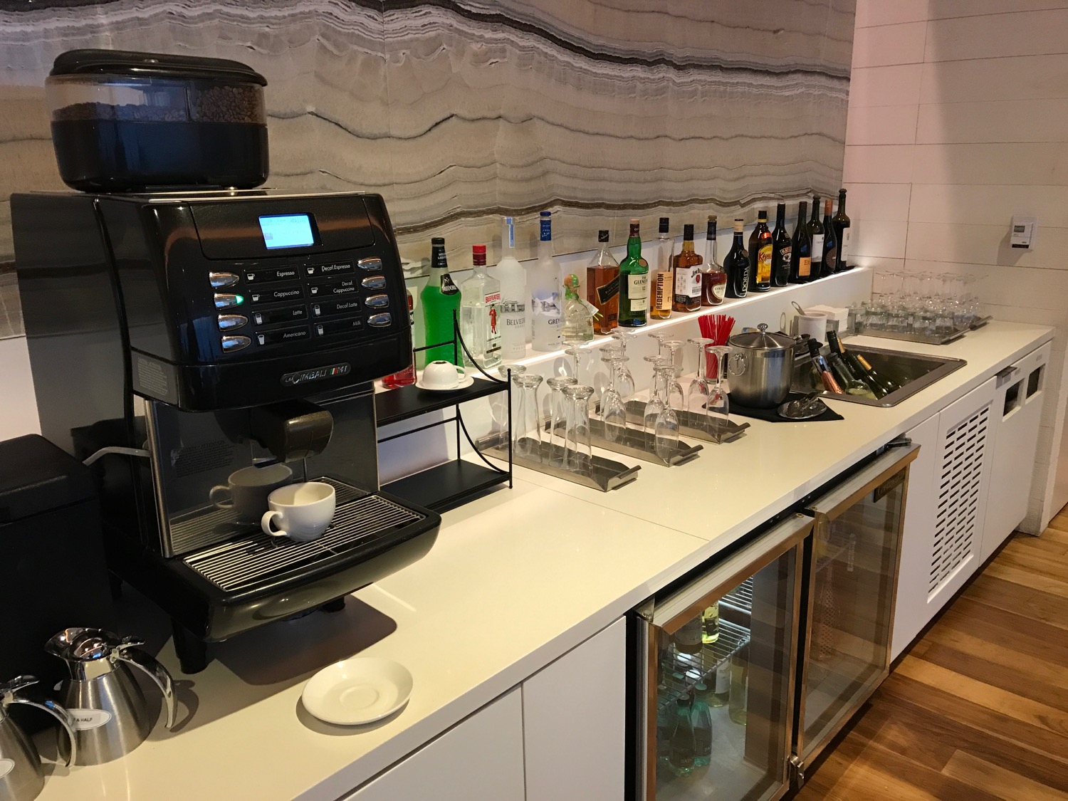 a coffee machine and glasses on a counter
