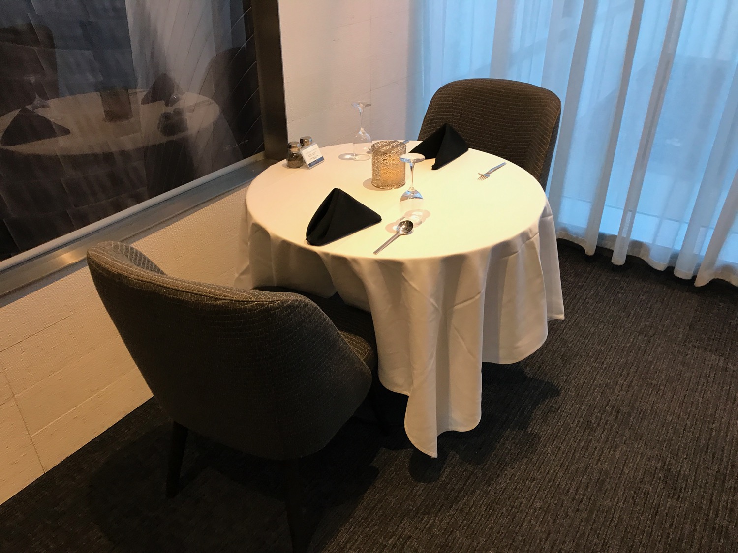 a table with a white tablecloth and silverware on it