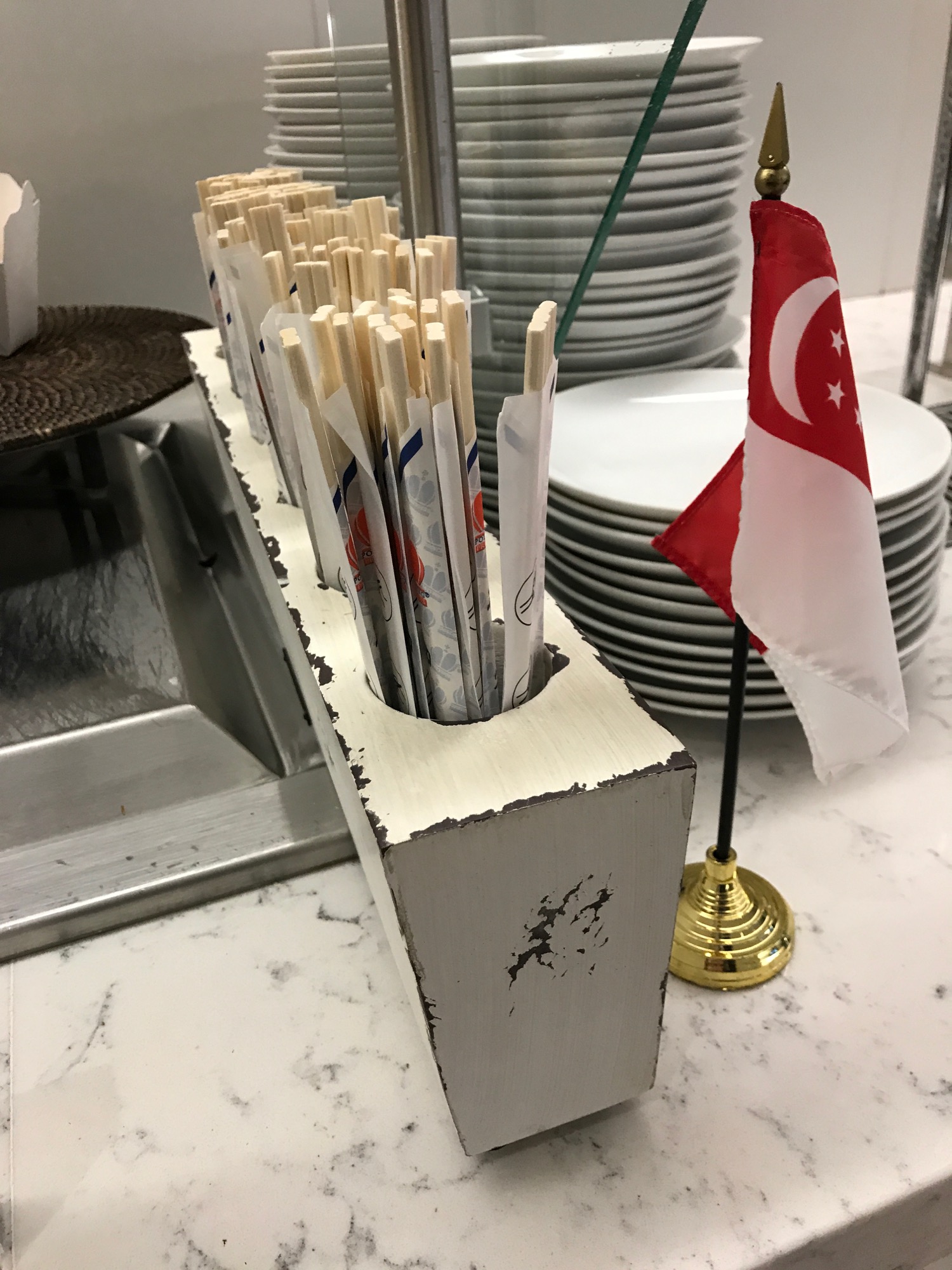a wooden container with chopsticks in it