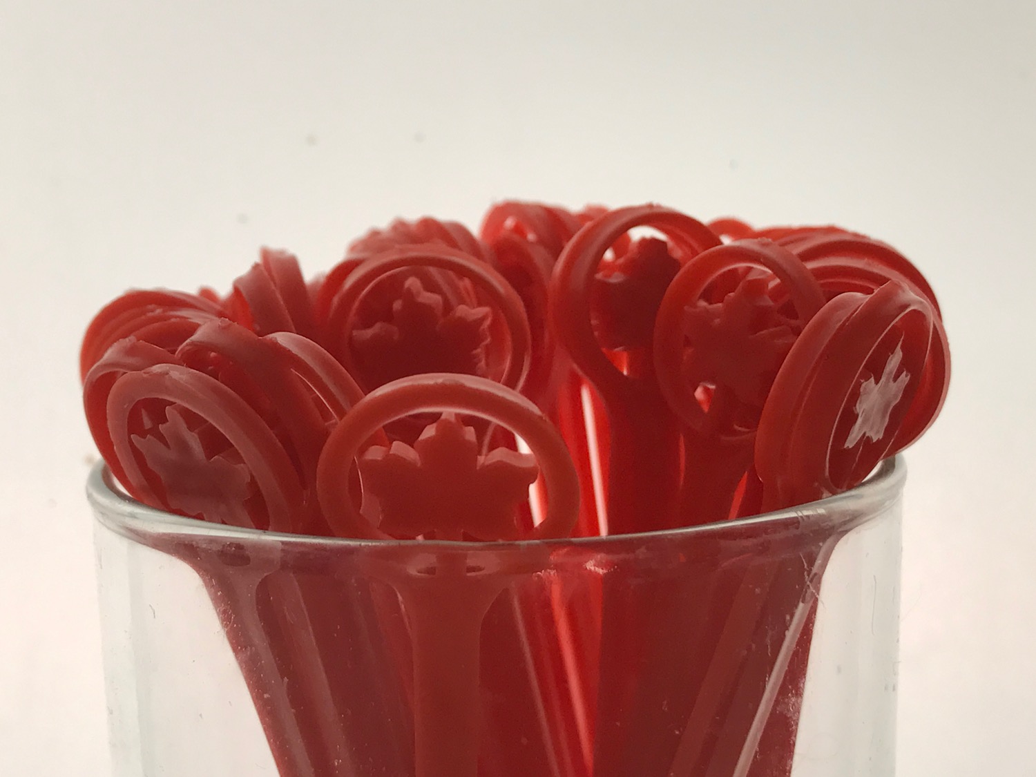 a glass with red plastic objects