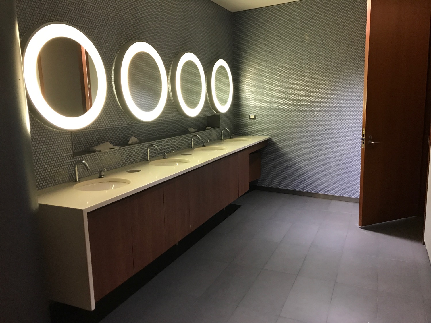 a bathroom with sinks and lights