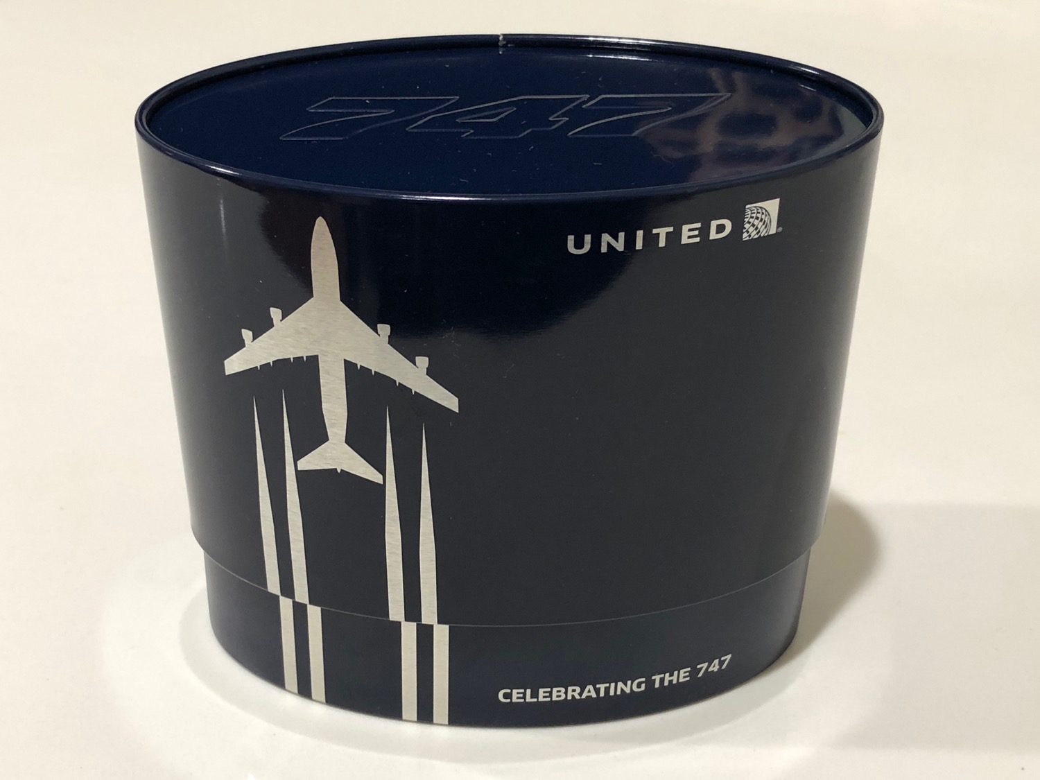 a blue round container with a plane logo