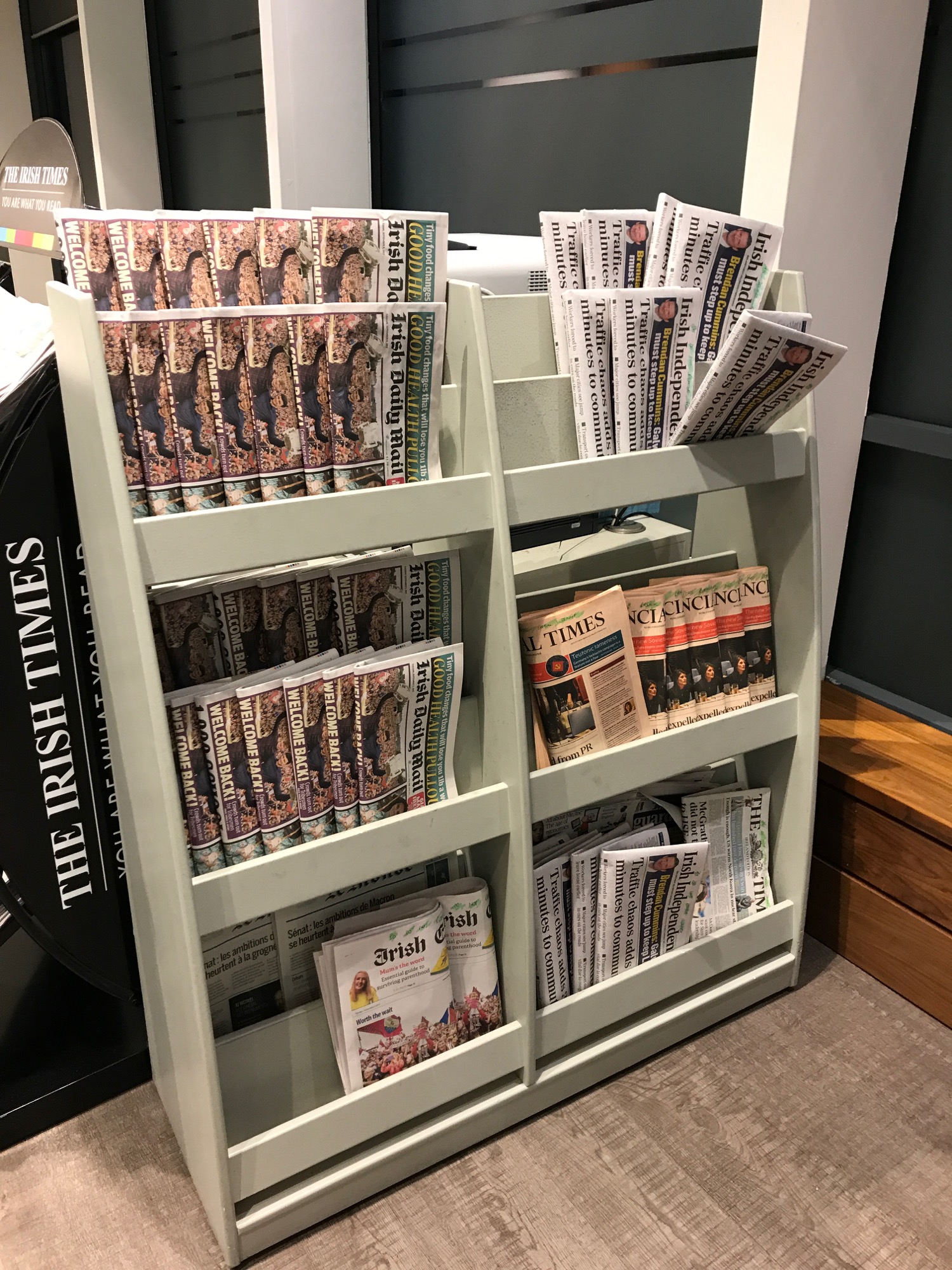 a shelf with newspapers and magazines