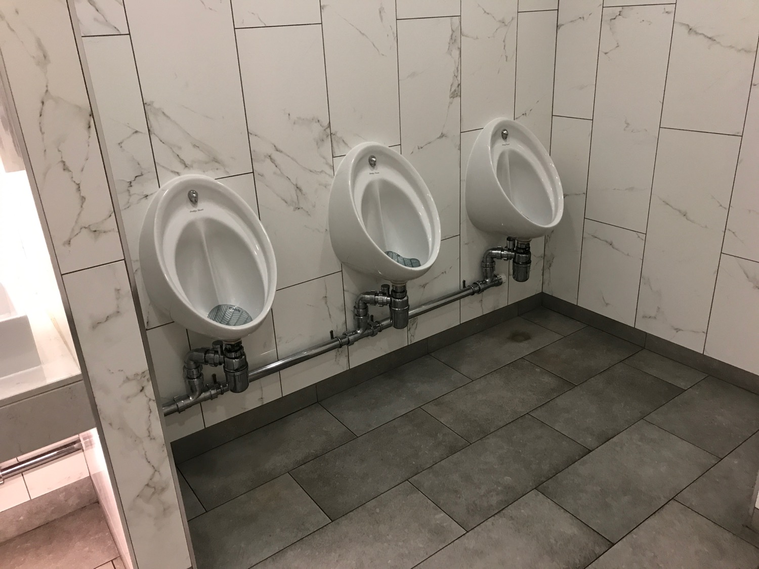 a row of urinals in a bathroom