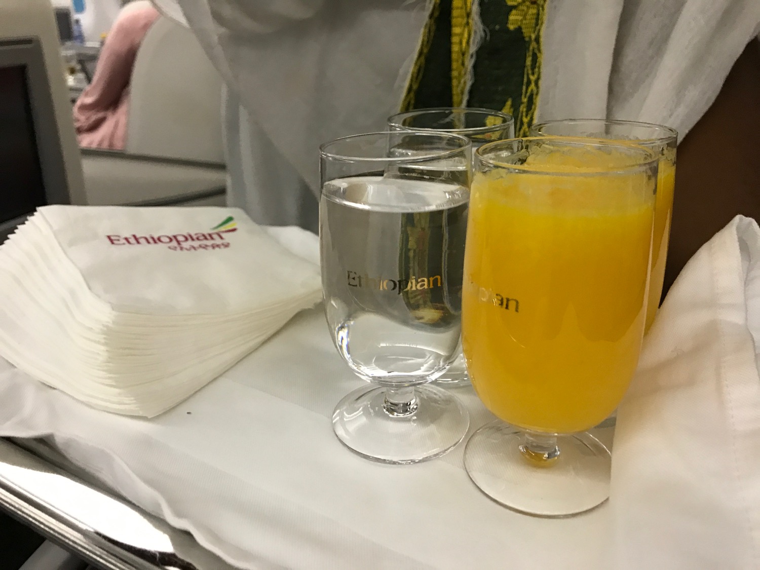 glasses of liquid and orange juice on a table