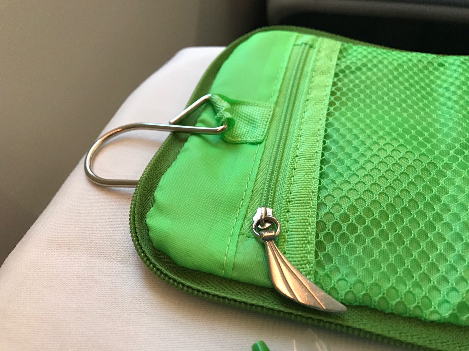 a green pouch with a metal handle