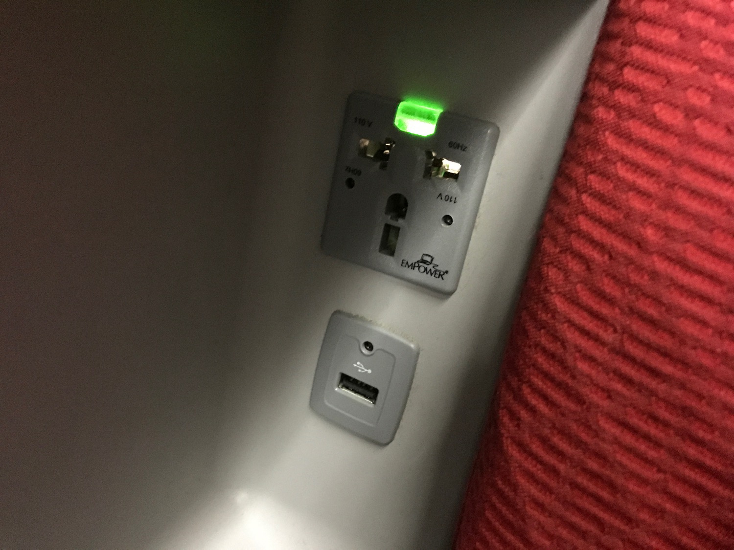 a wall outlet with a green light