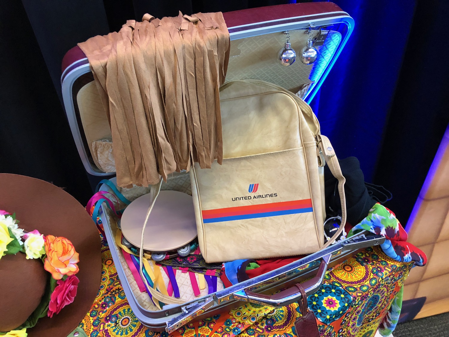 a suitcase with a bag and scarfs