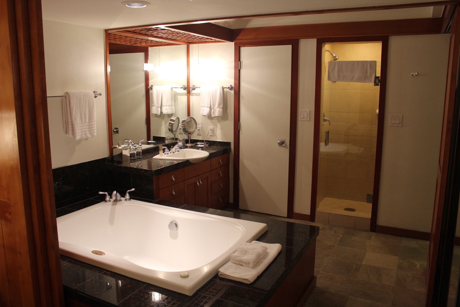 a bathroom with a large tub and sink