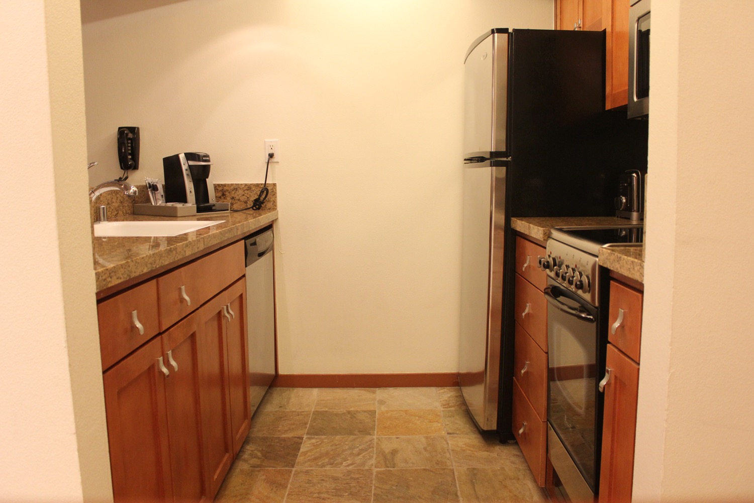 a kitchen with a black refrigerator and a black stove