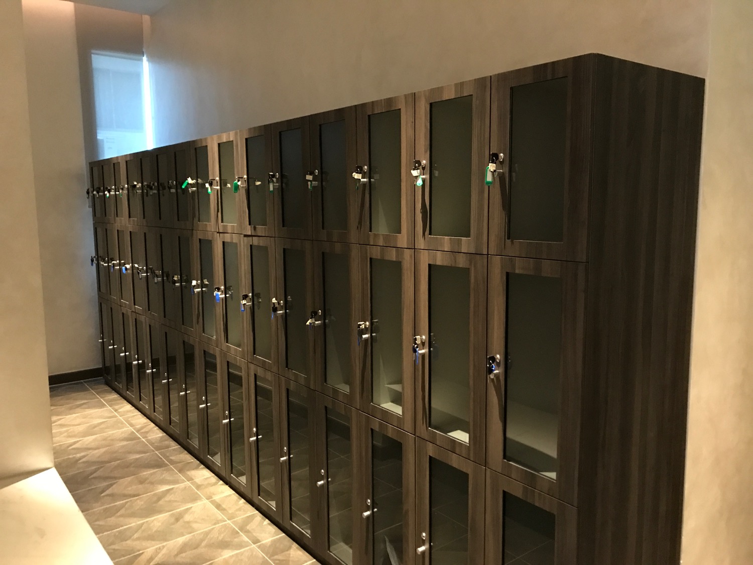 a row of lockers with glass doors