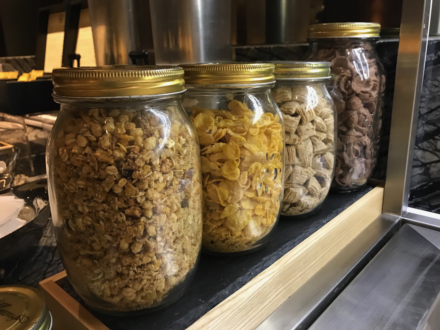 a group of glass jars with cereal