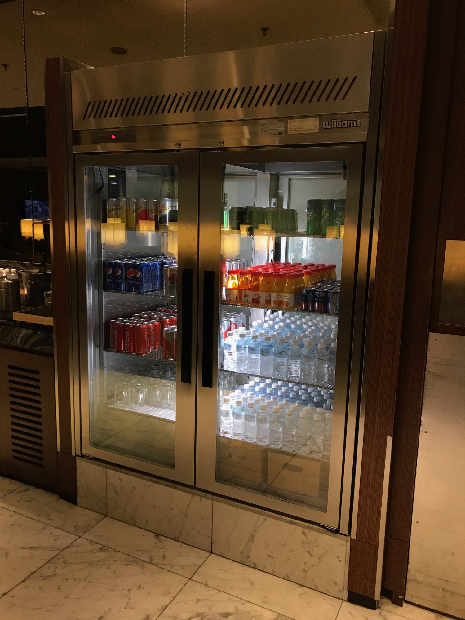 a refrigerator with drinks and cans