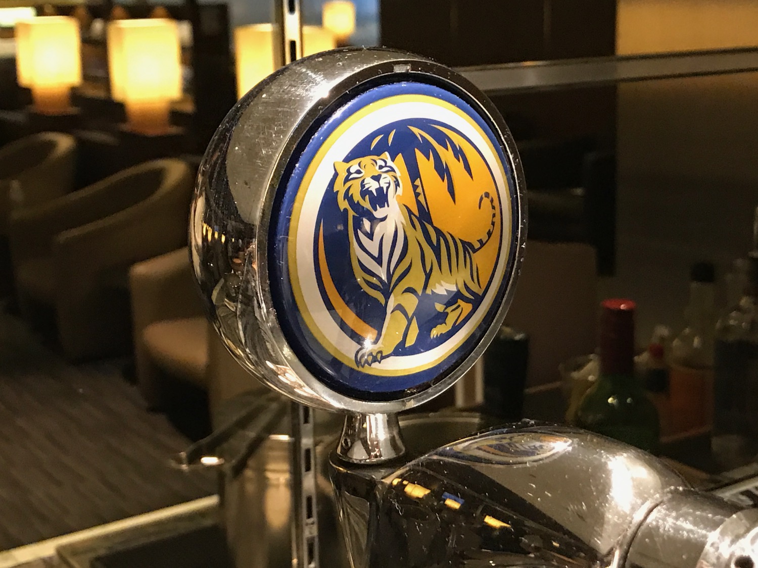 a beer tap with a tiger logo