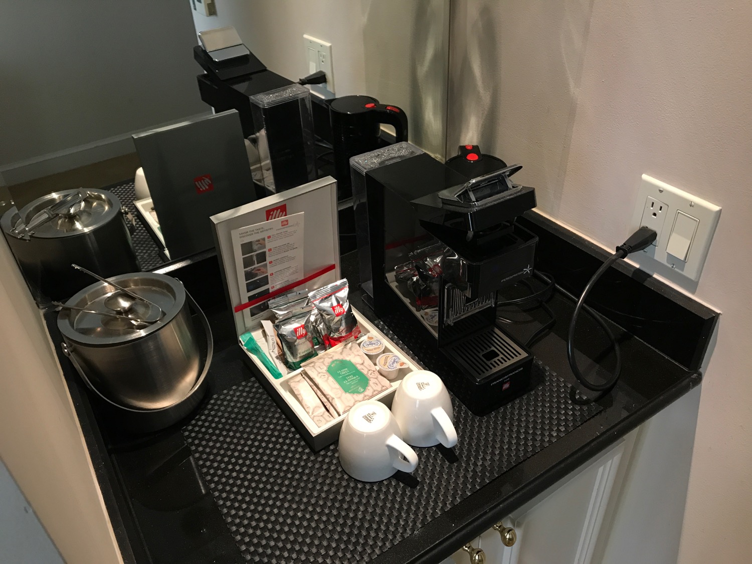a coffee machine and tea cups on a counter