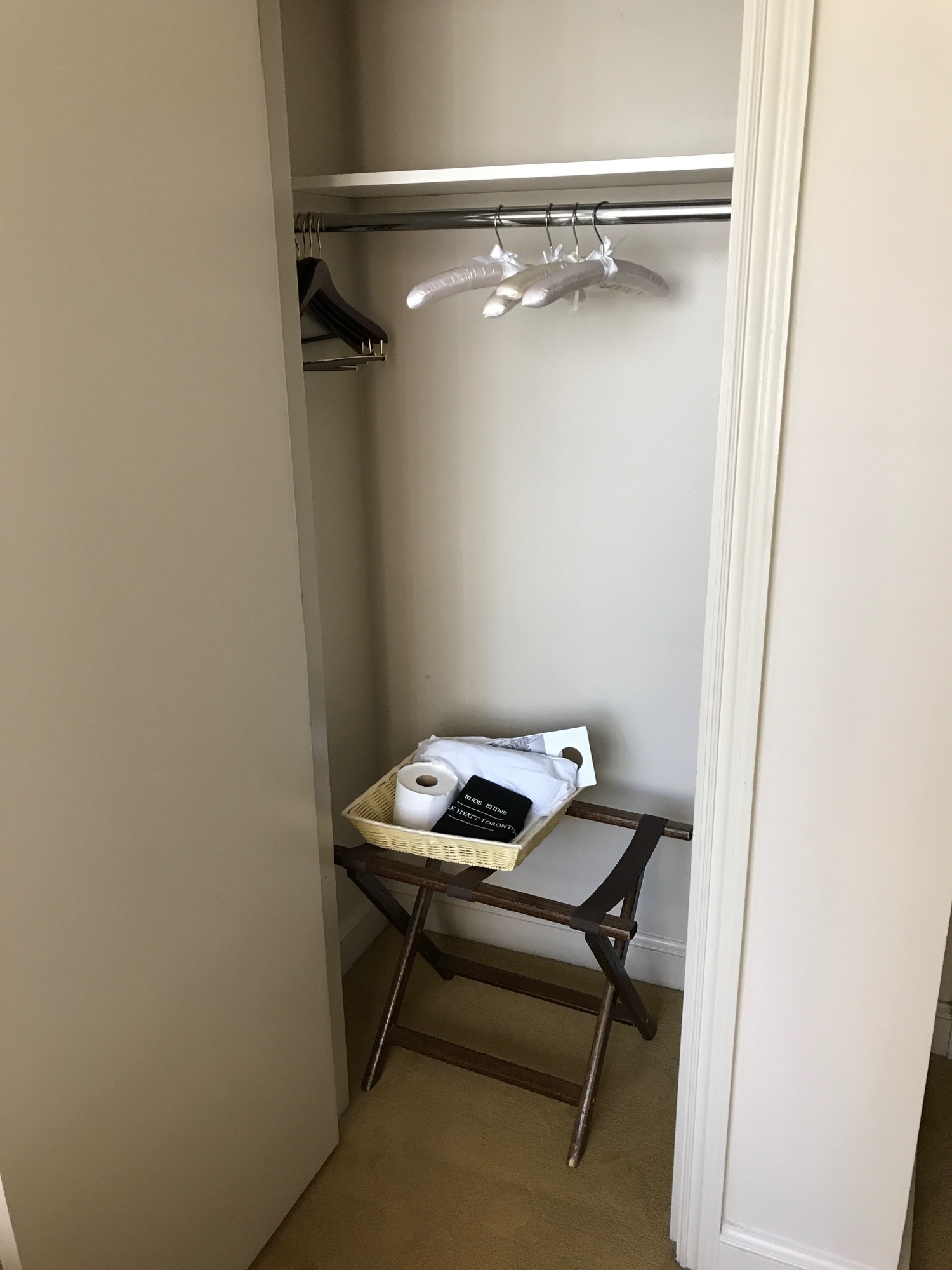 a closet with a tray of food and a tray of towels