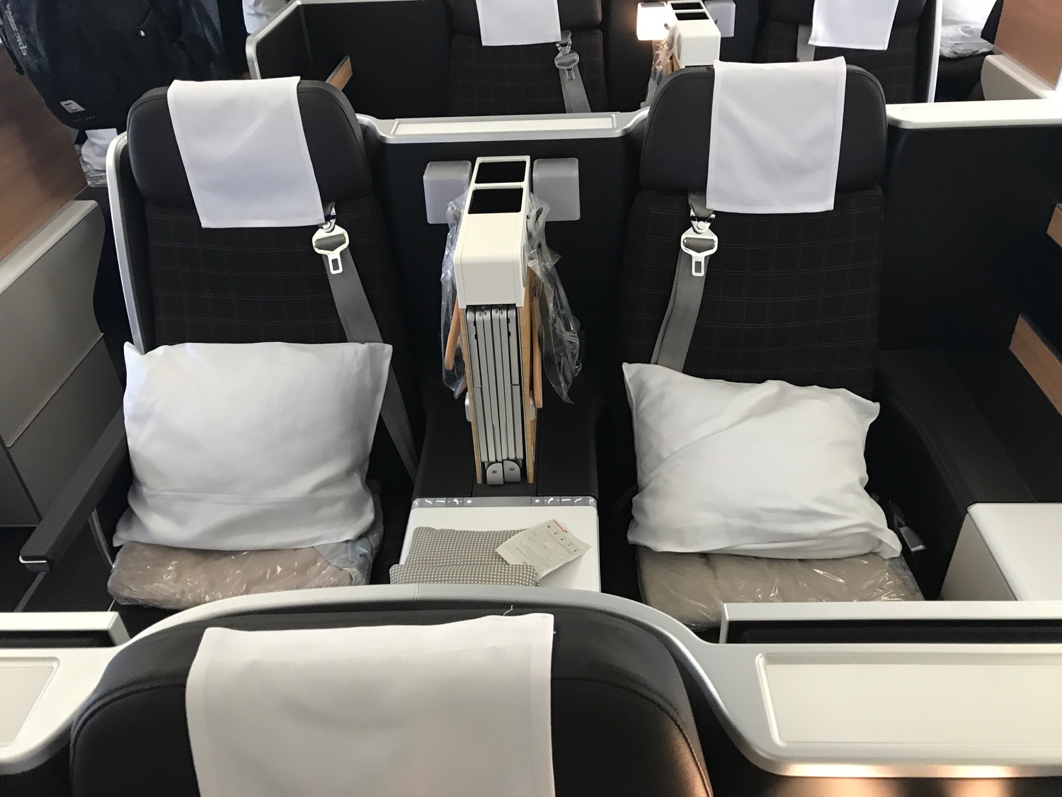 a row of seats with white pillows