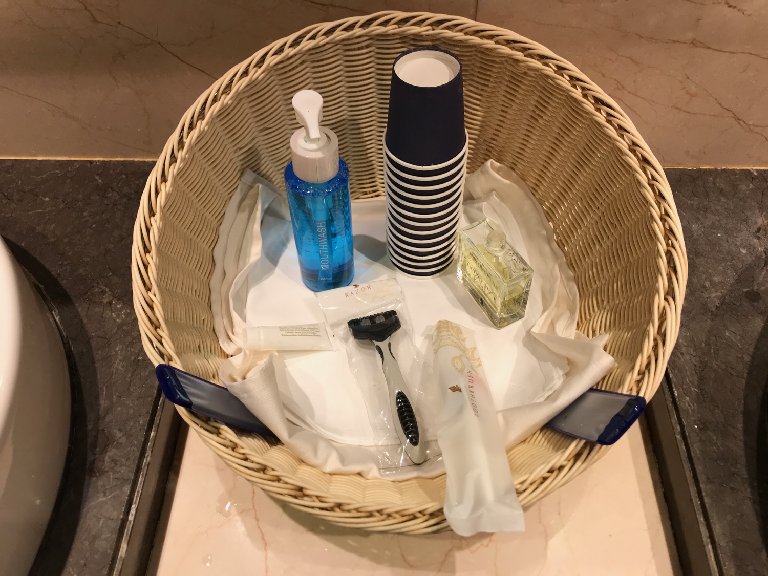 a basket with a lotion and razor and other items
