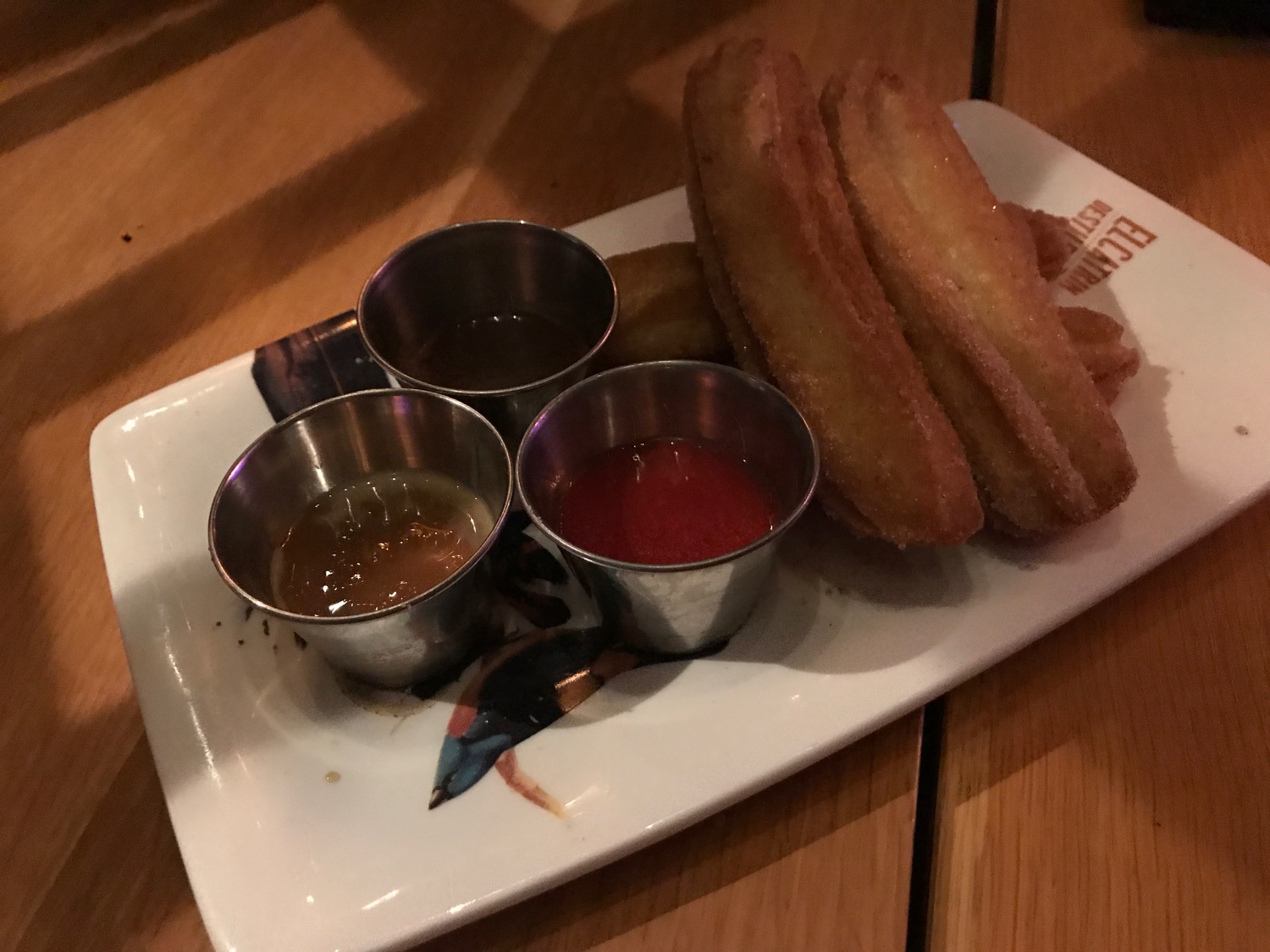 a plate of churros and sauces