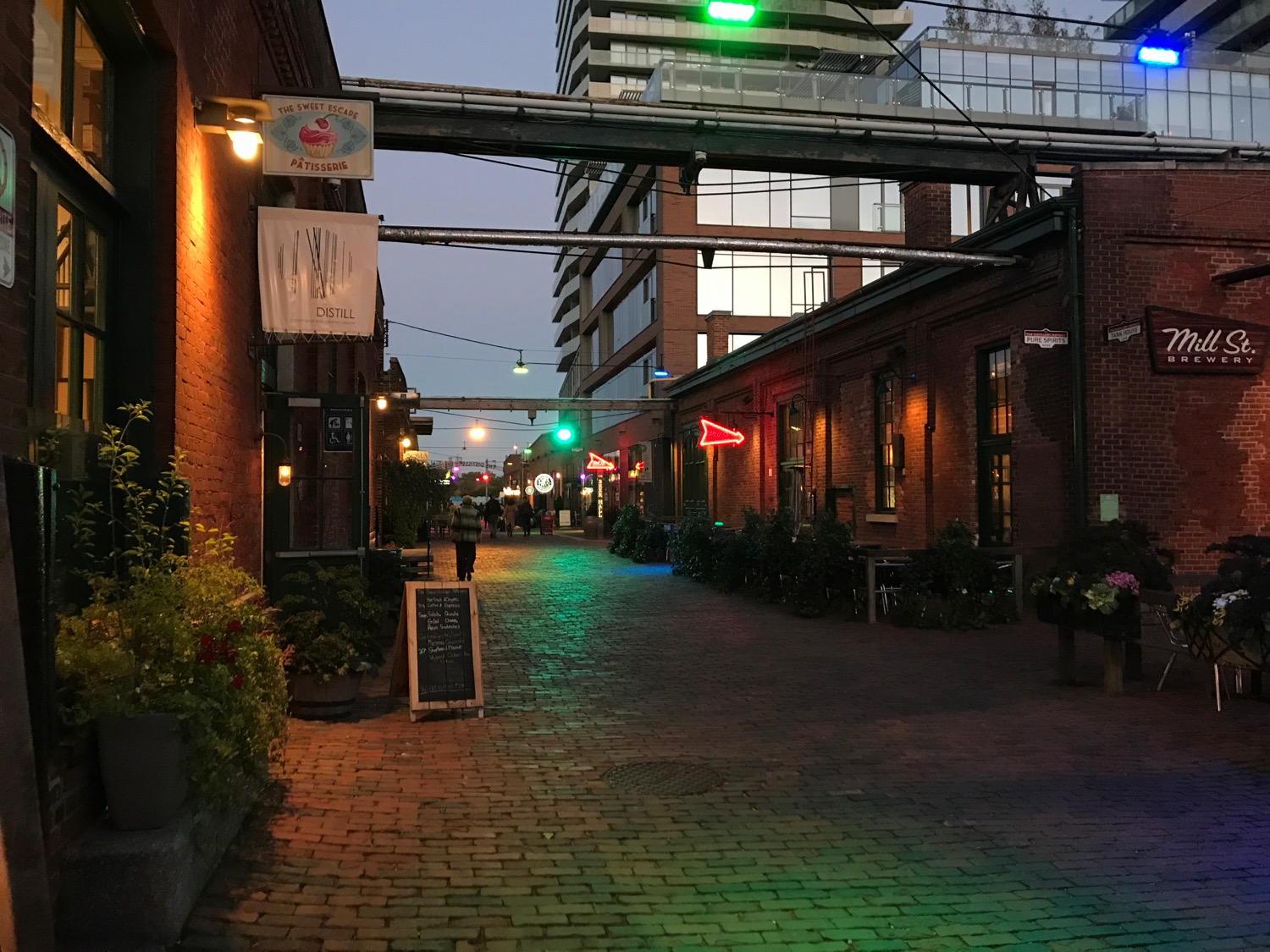 a brick walkway with green lights