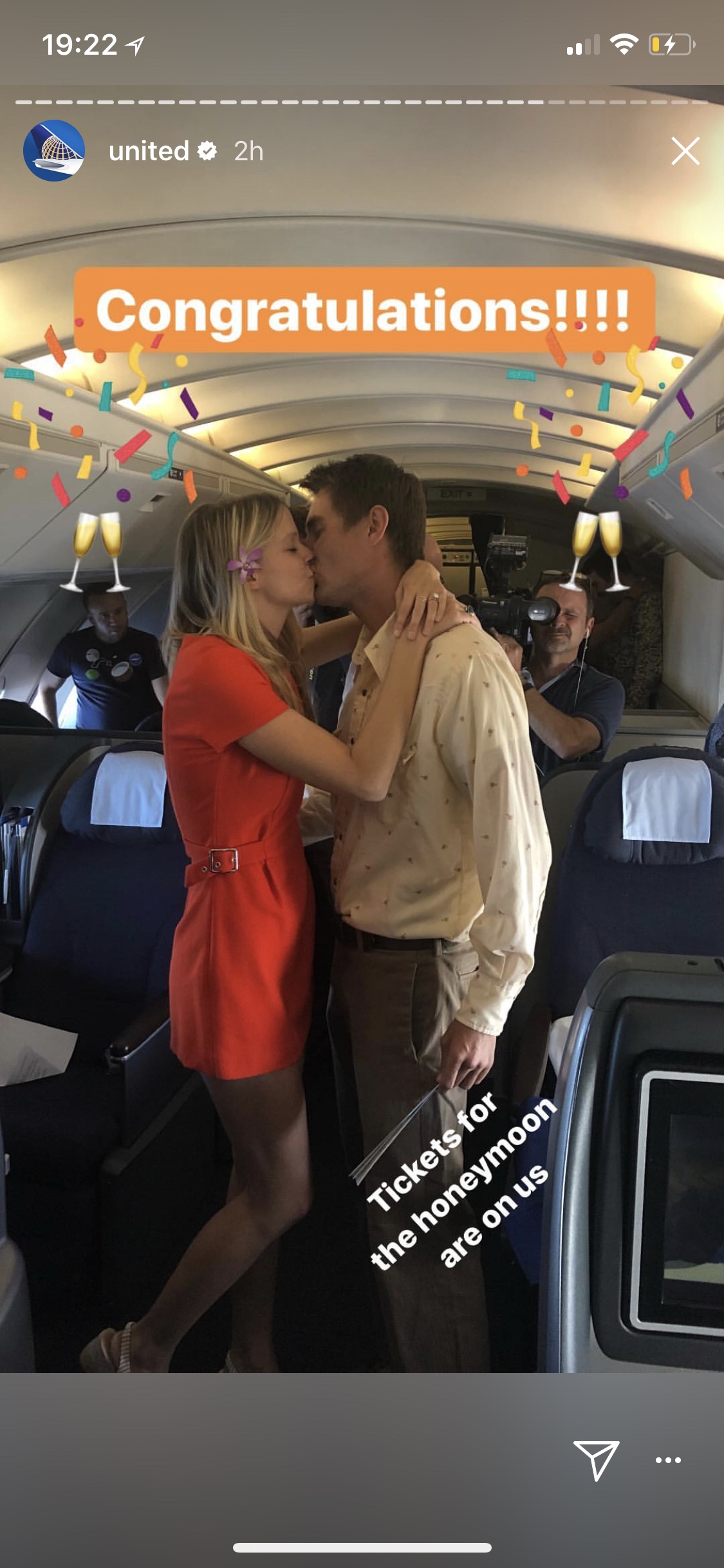 a man and woman kissing on an airplane