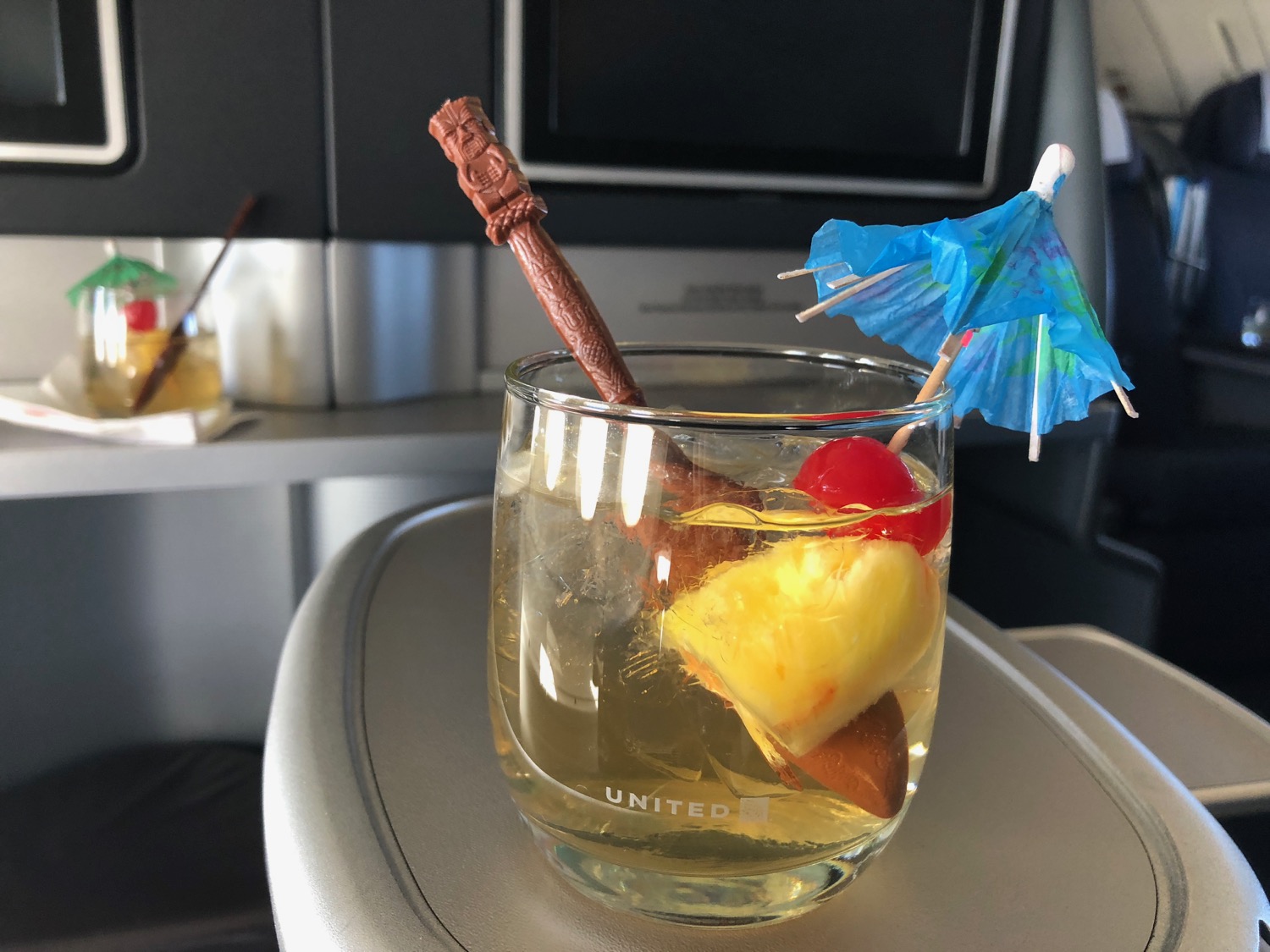 a drink with a straw and umbrella in it