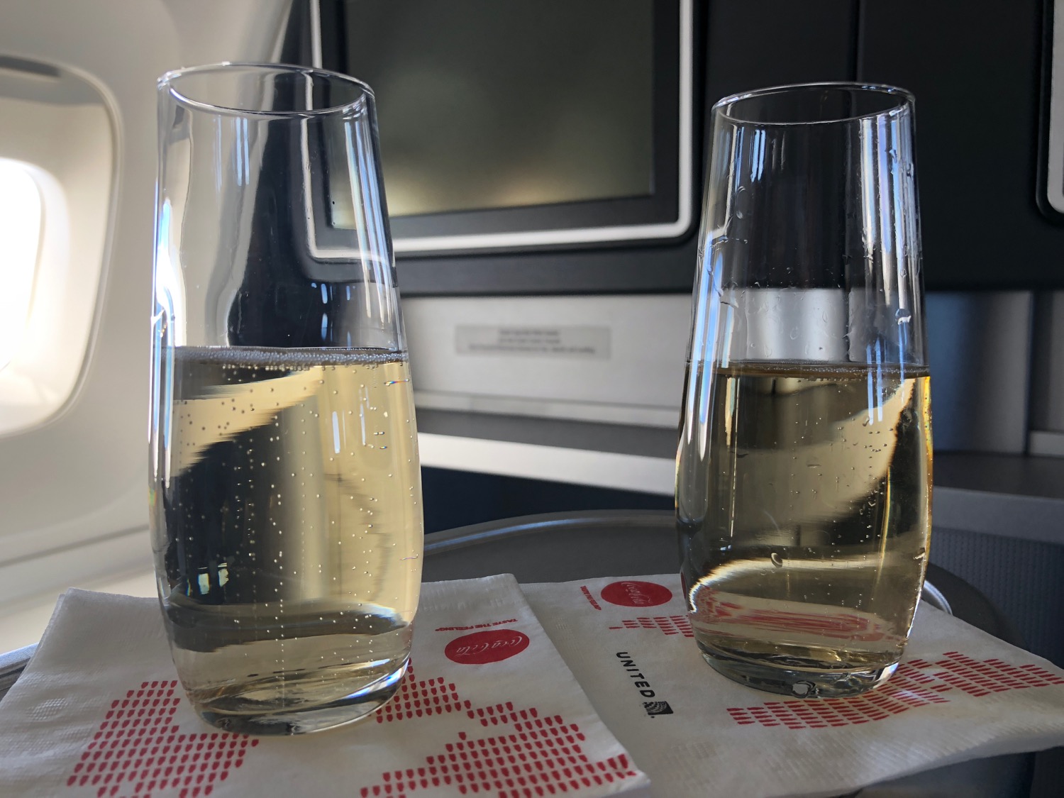 two glasses of champagne on a tray