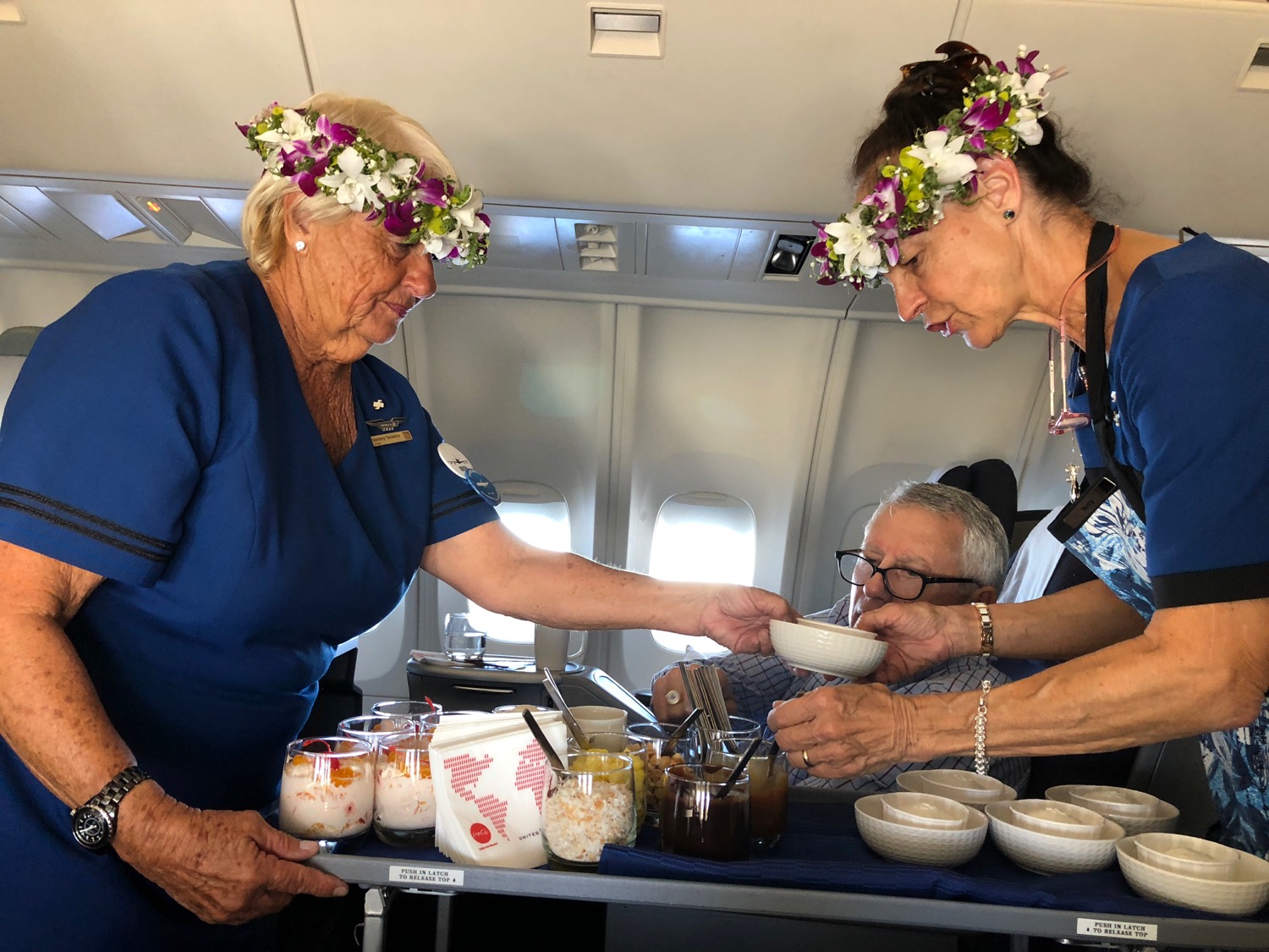 a group of people on an airplane serving food