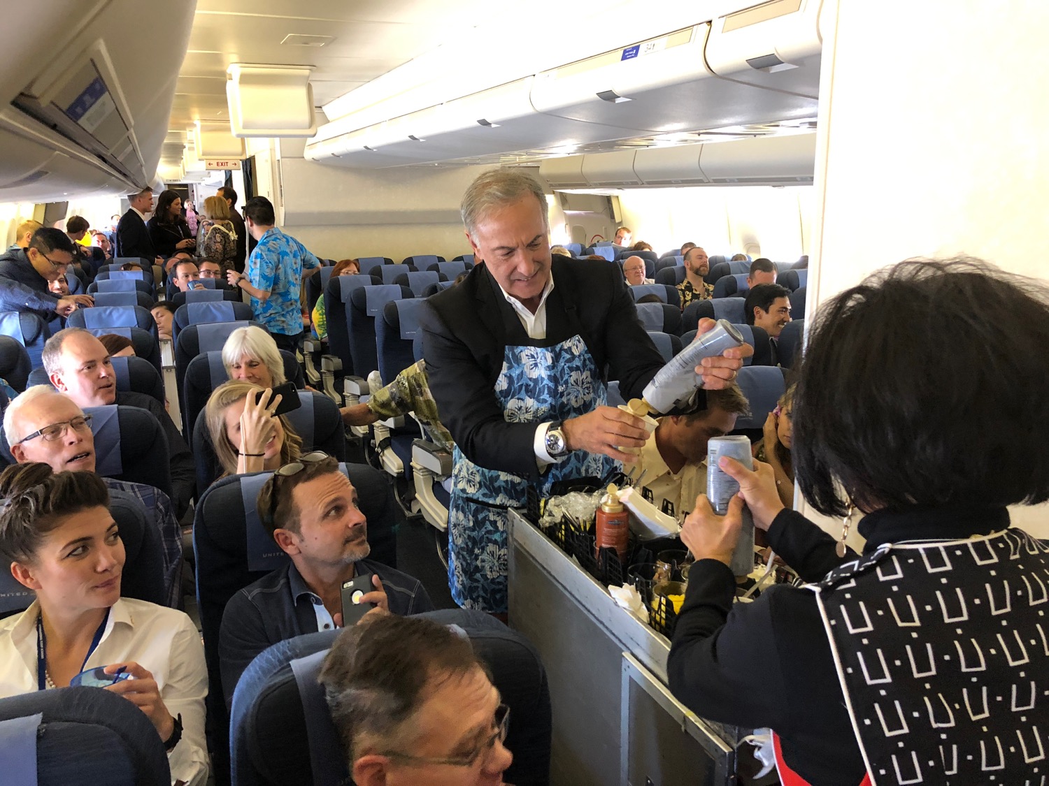 a man in an airplane serving drinks