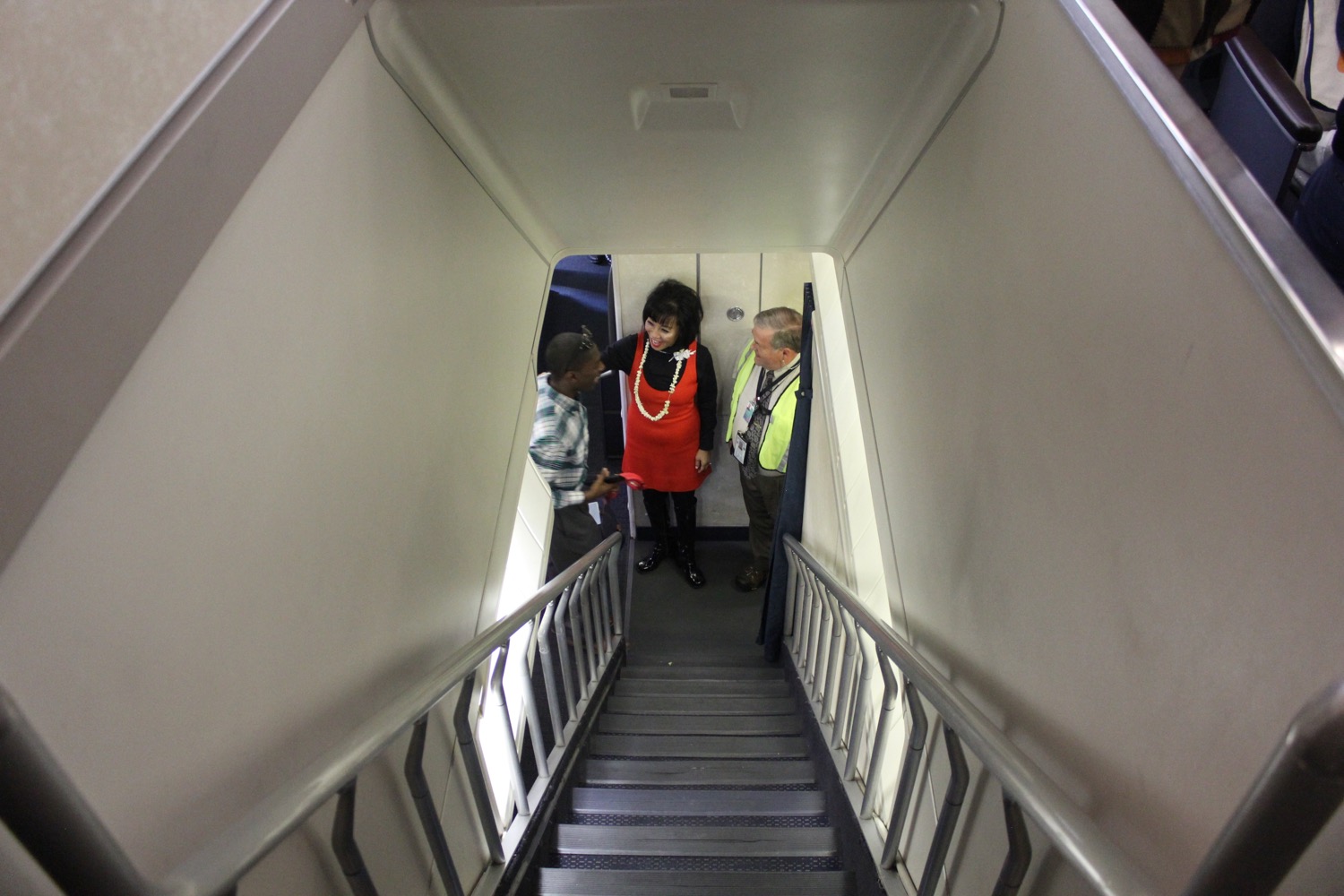 a group of people standing on a plane stairs