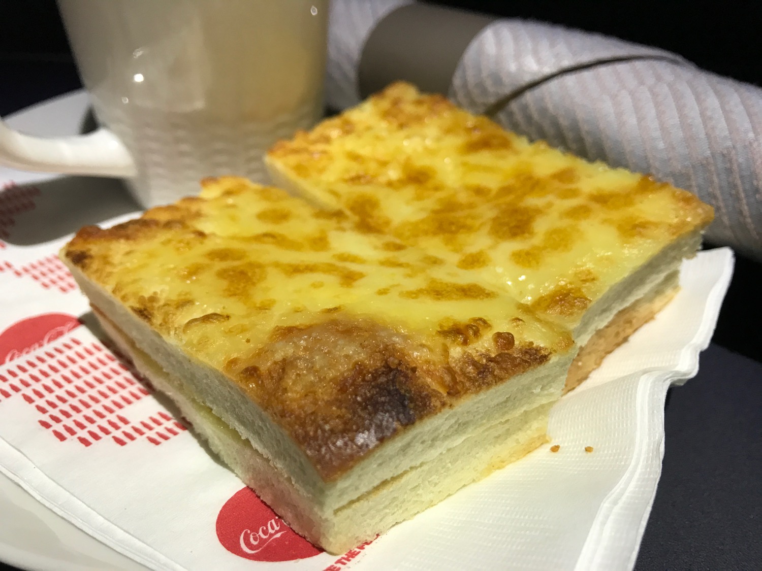 a slice of cheese bread on a napkin