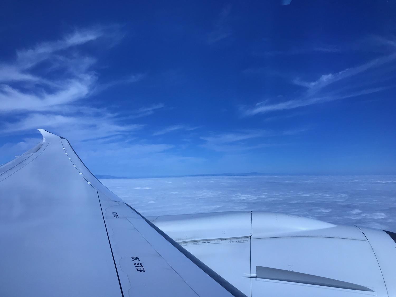 an airplane wing and clouds in the sky