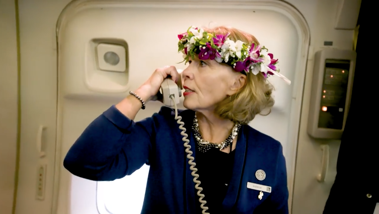 a woman wearing a flower crown on a telephone