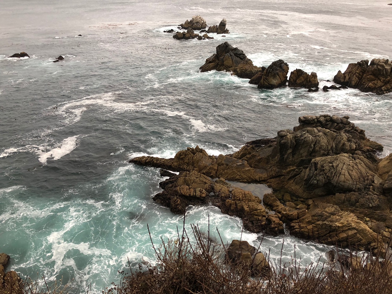 a rocky coastline with waves crashing on the rocks