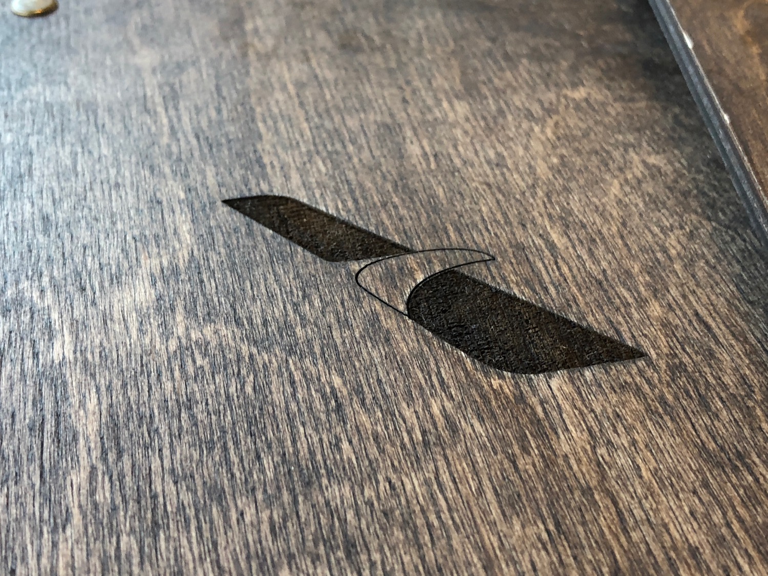 a logo on a wood surface