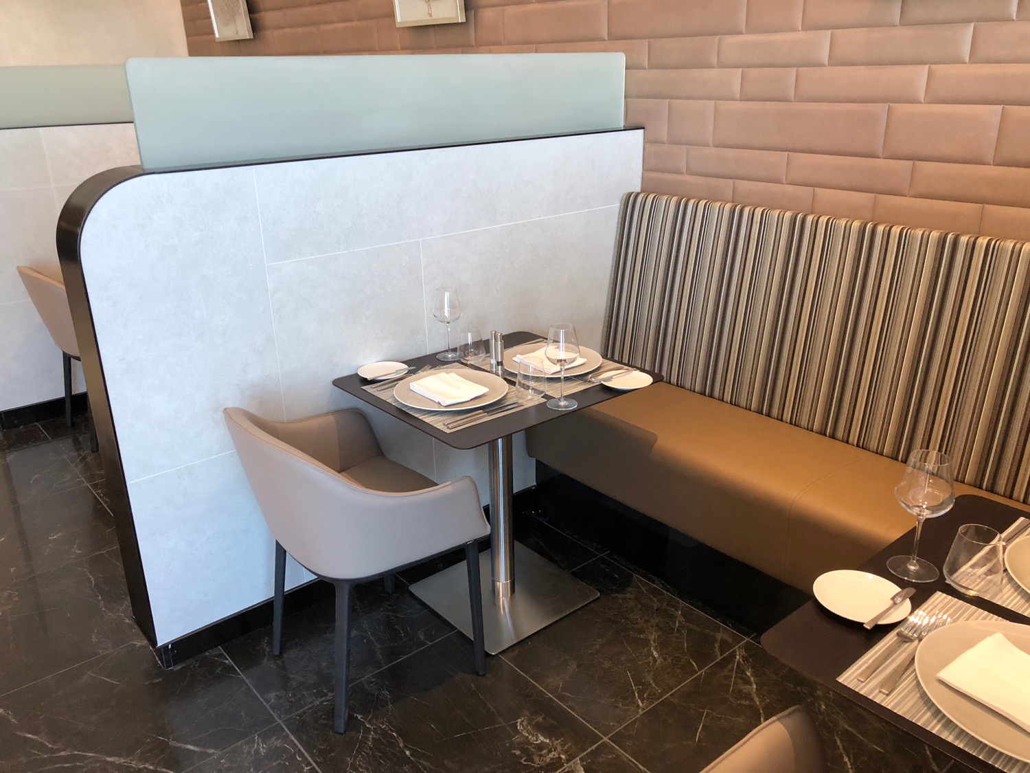 a table with plates and chairs in a restaurant
