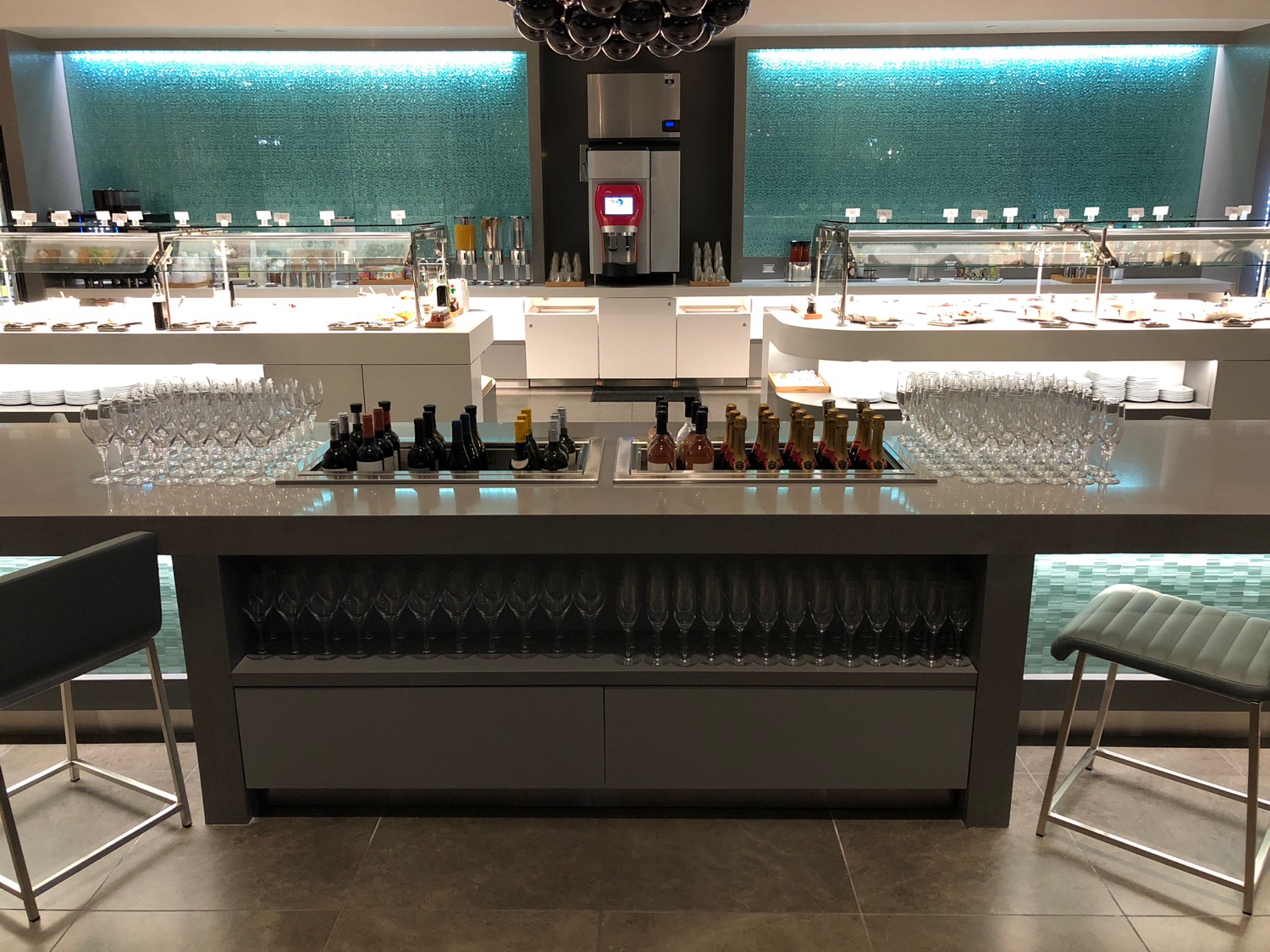 a bar with many wine glasses and bottles
