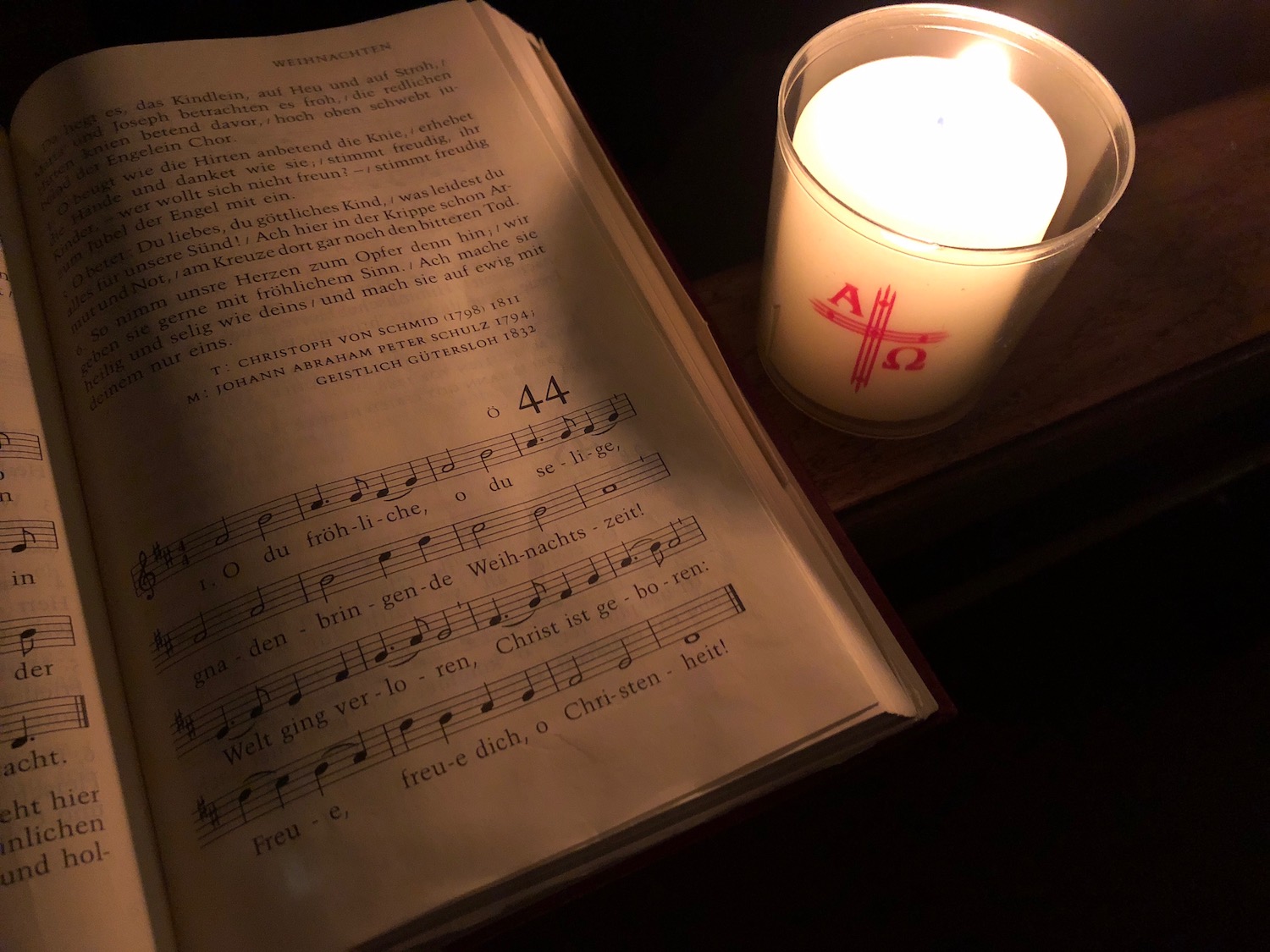 a candle and book with music notes