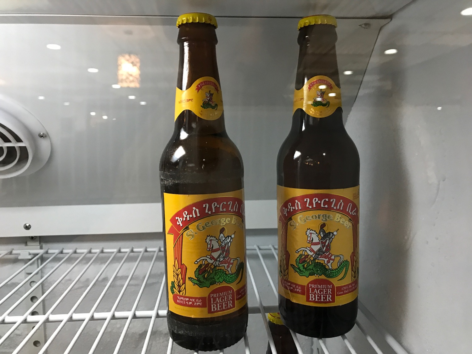 two bottles of beer in a refrigerator