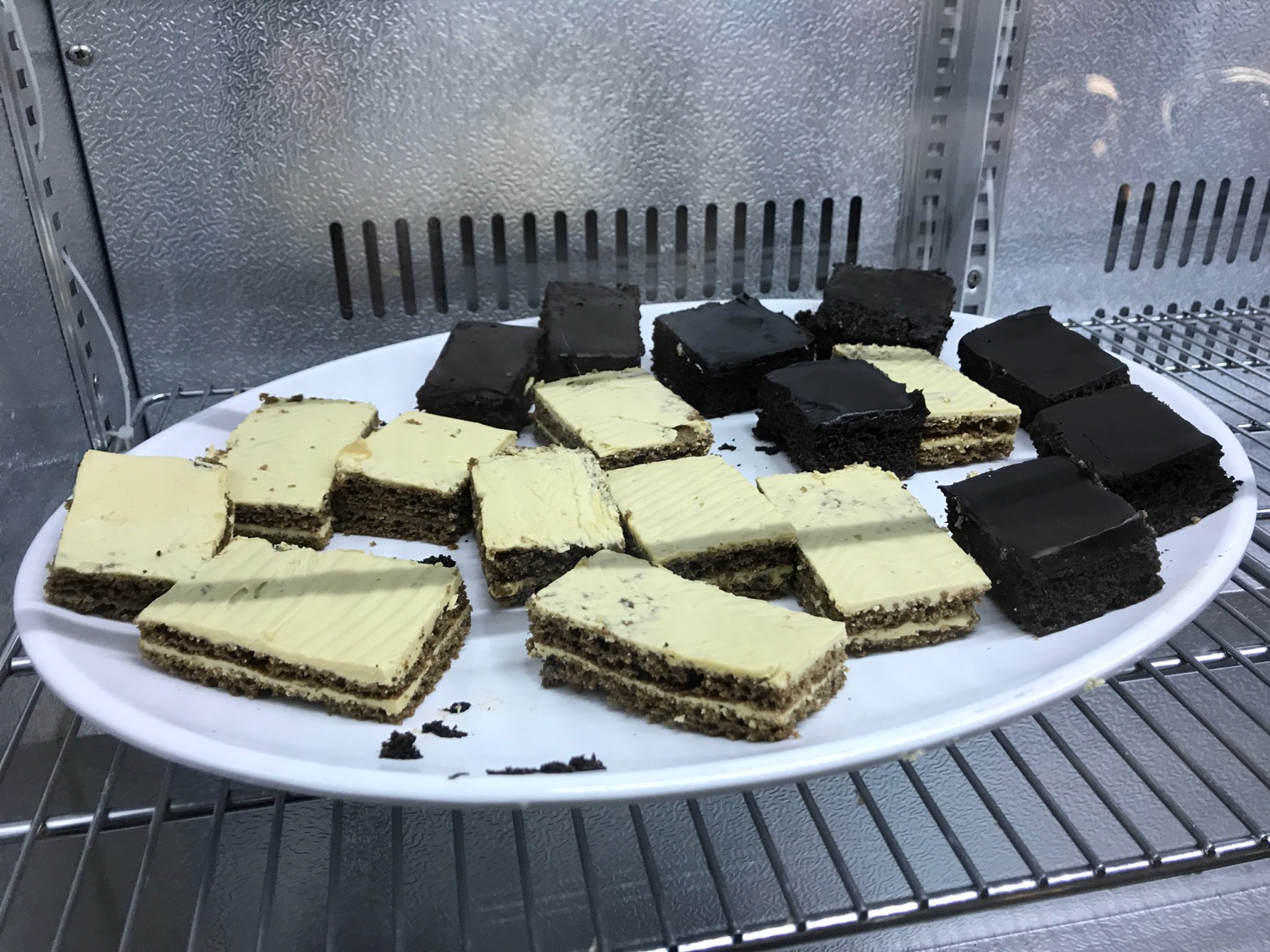 a plate of brownies on a shelf
